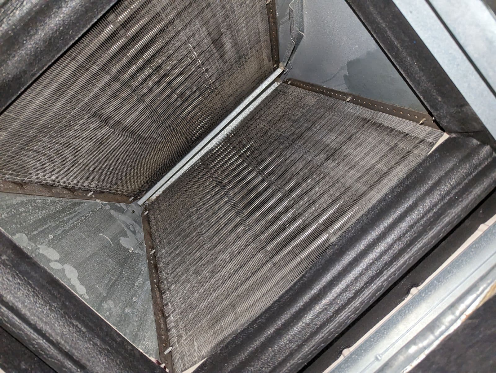 Evaporator coil inspection during HVAC maintenance service in Meridian Idaho