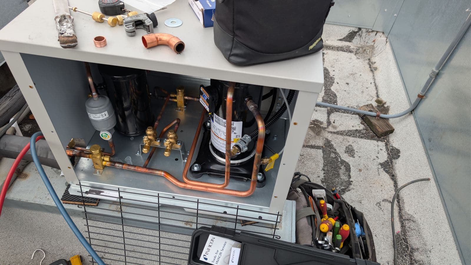Professional tools on a Trenton condensing unit being installed for a walk-in cooler