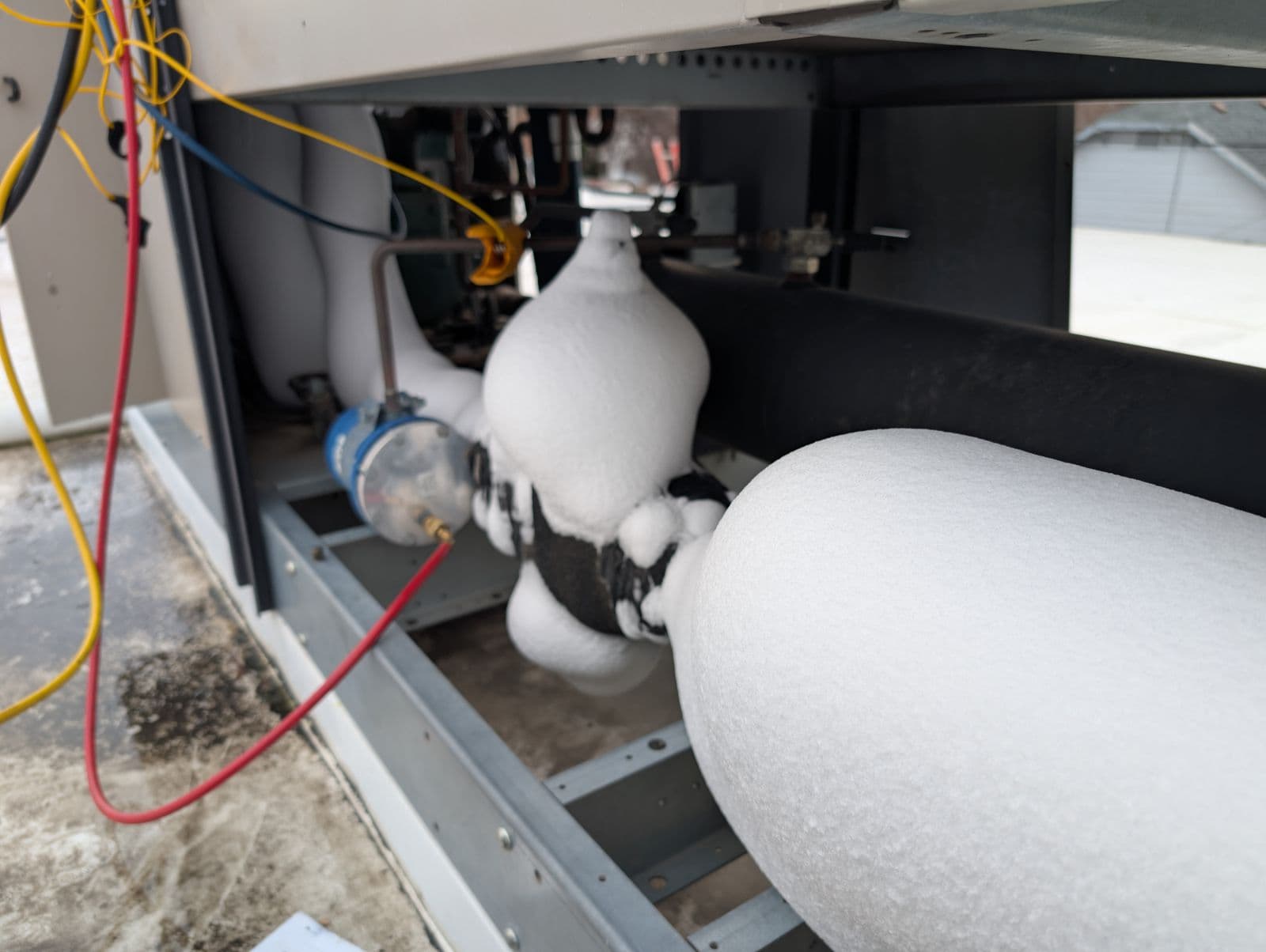 Commercial refrigeration system with frost buildup being serviced in Meridian