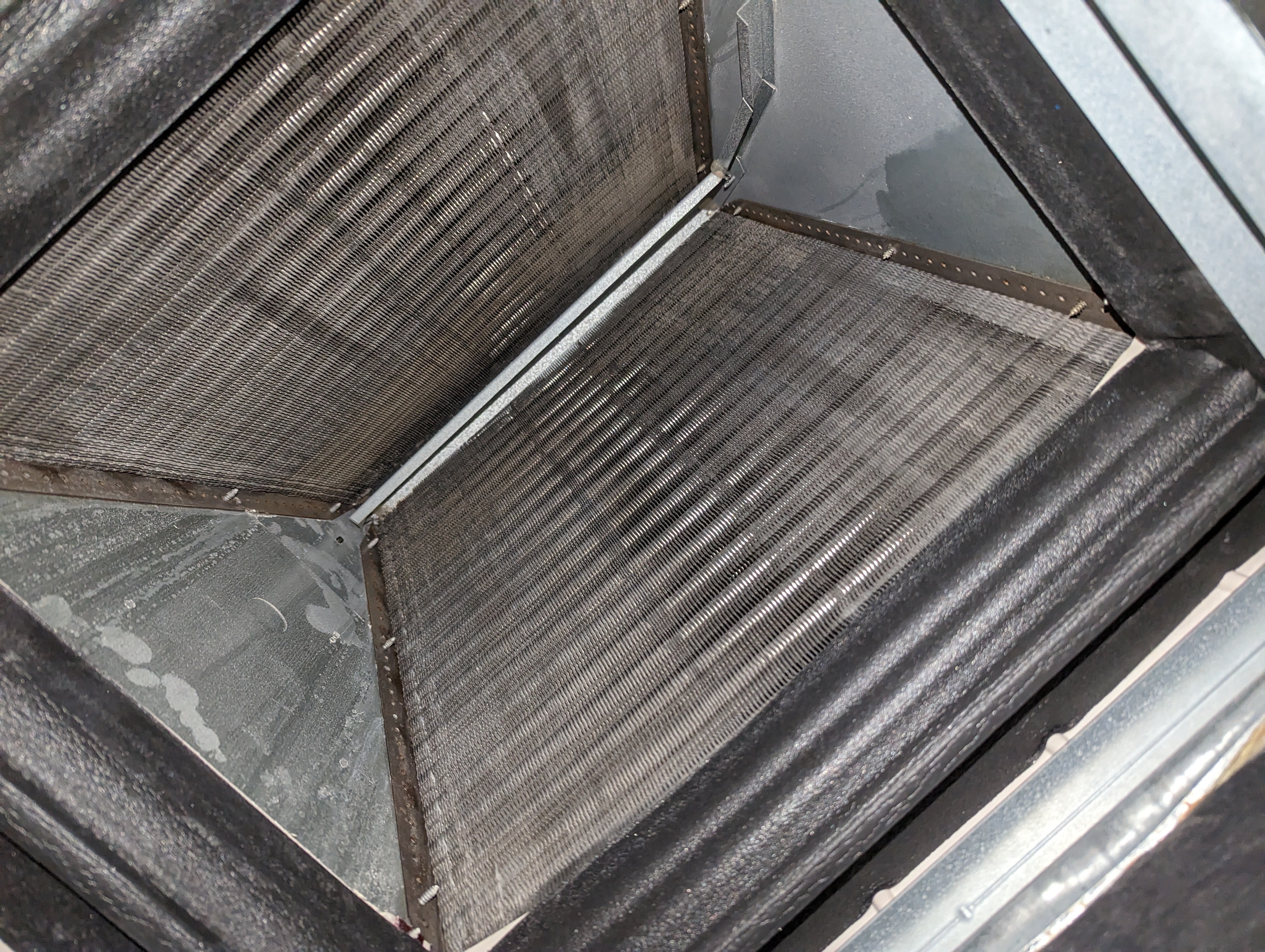 Evaporator coil inspection during HVAC maintenance service in Meridian Idaho