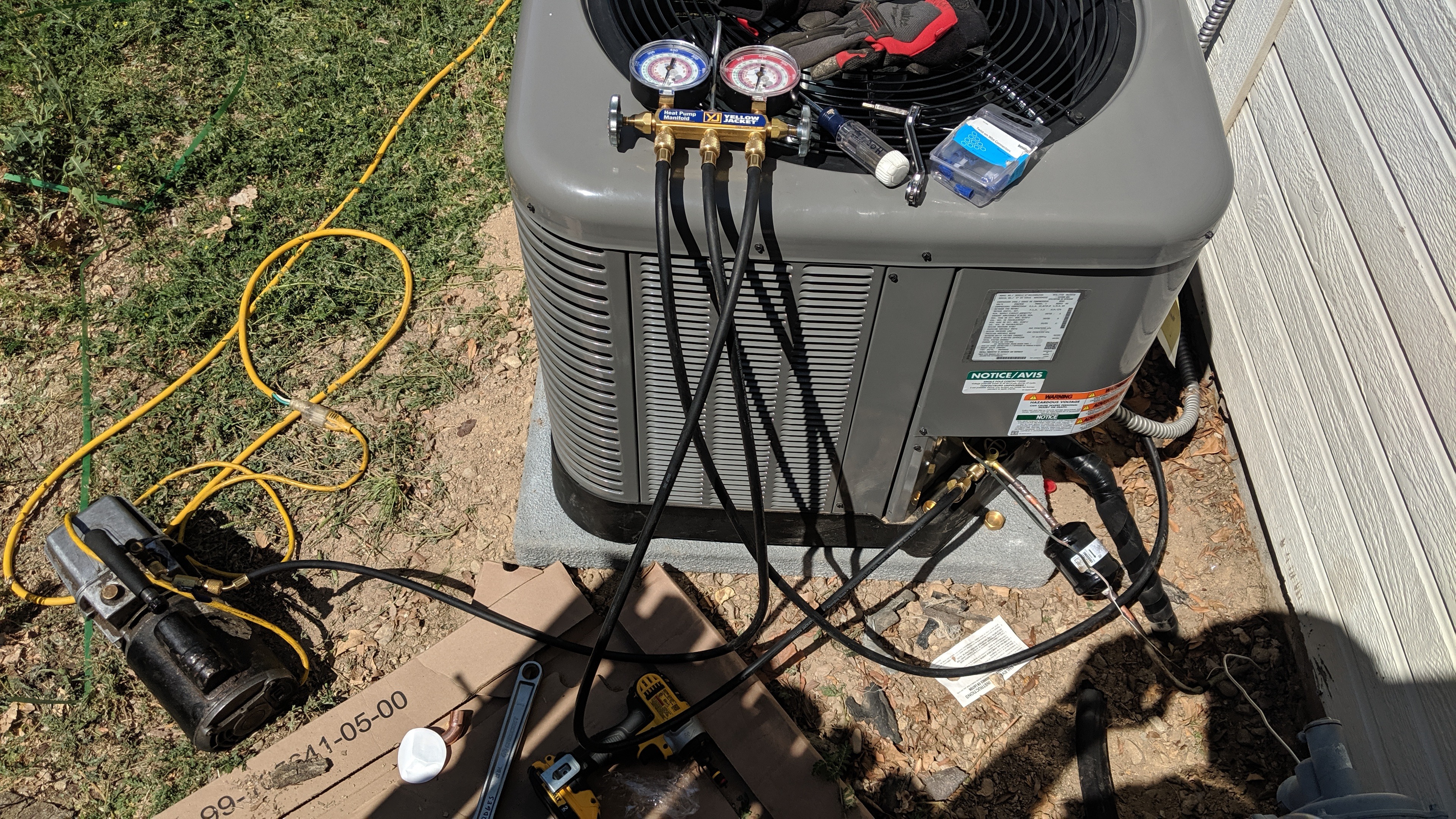 HVAC technician performing AC diagnostic with refrigerant gauges in Meridian Idaho