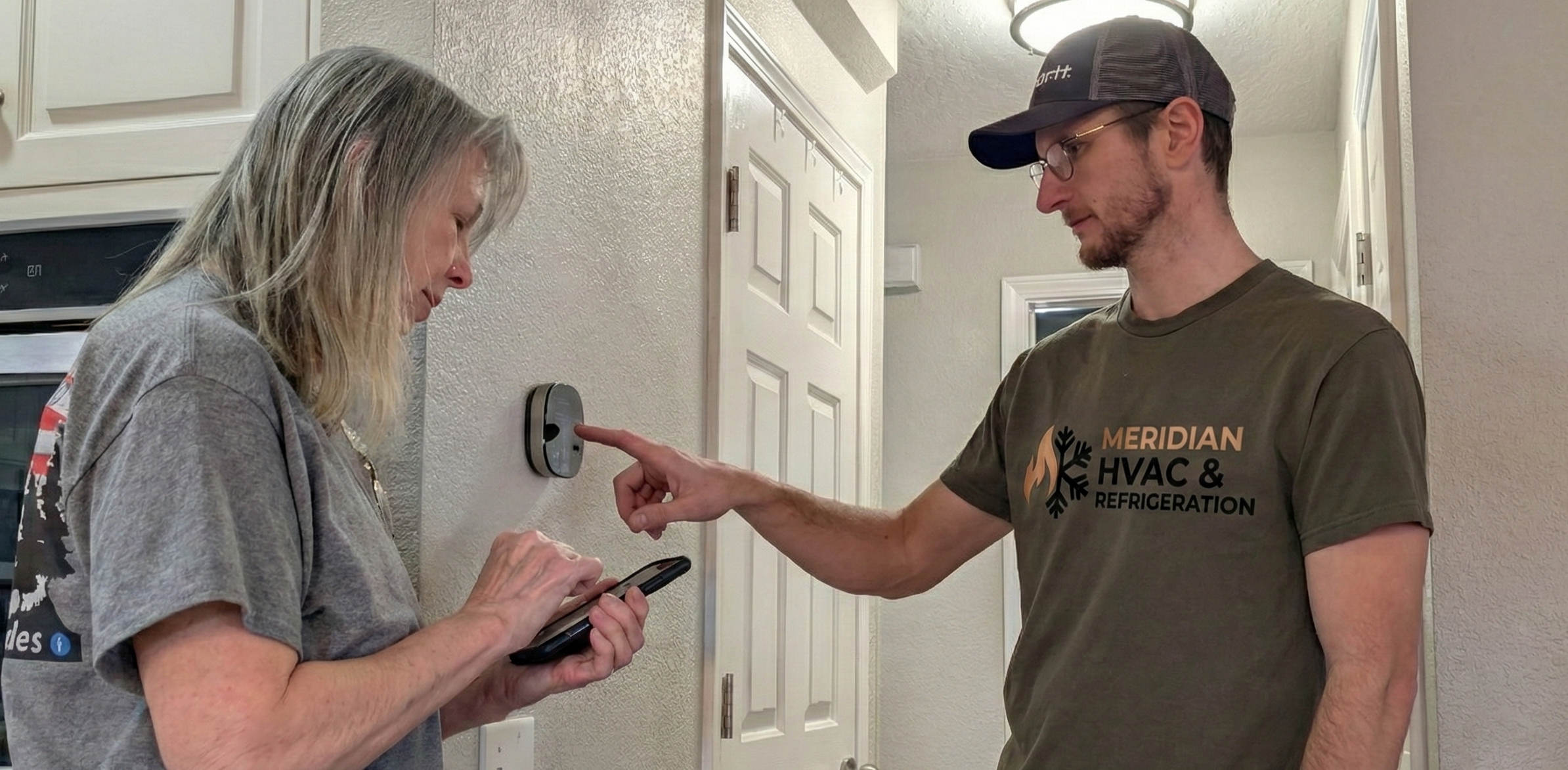 Meridian HVAC technician consulting with business owner about refrigeration controls