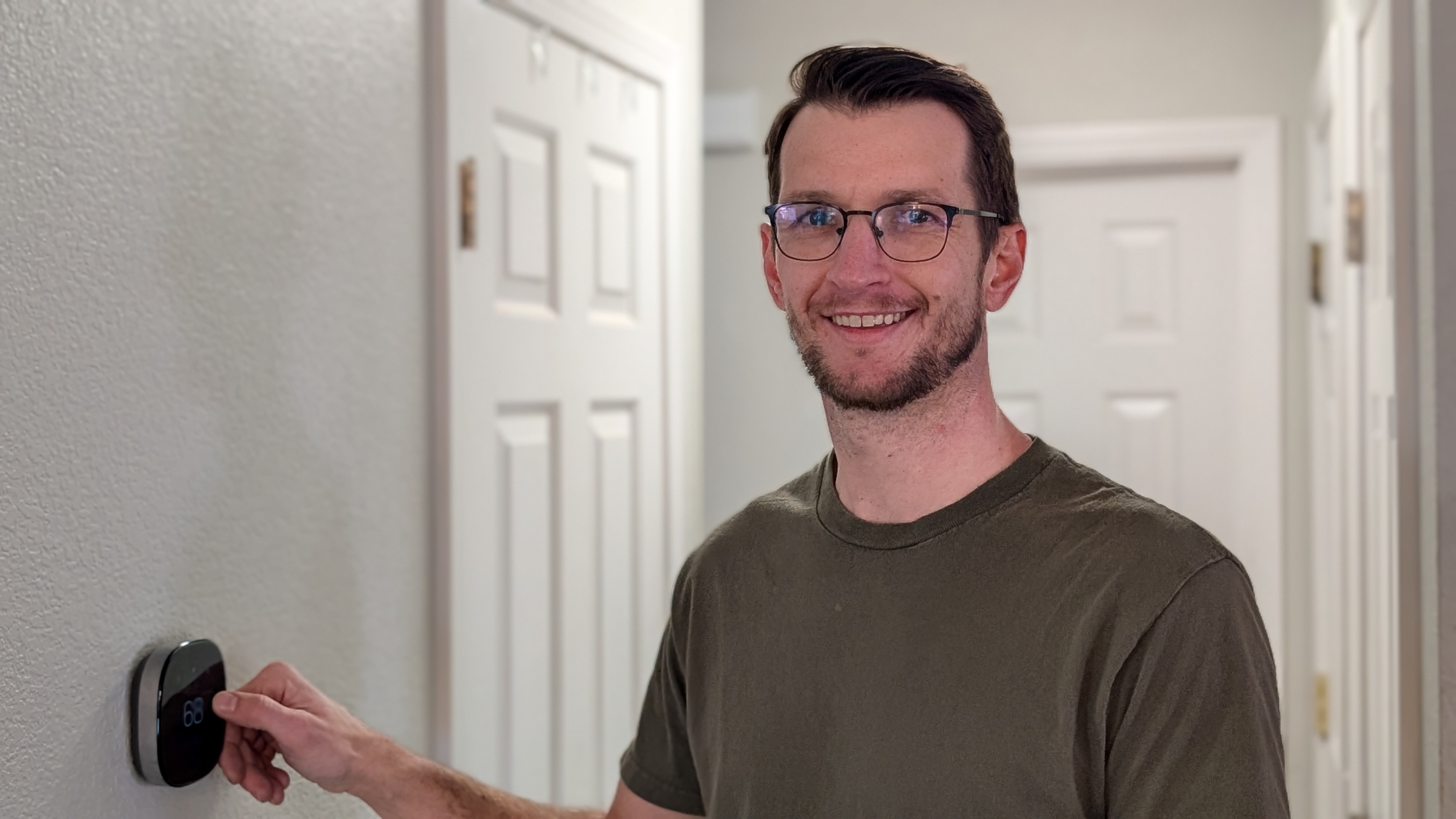 HVAC technician servicing thermostat in Nampa home